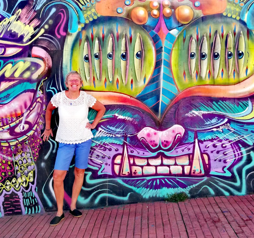 Me posing with street art in Bogota, Colombia