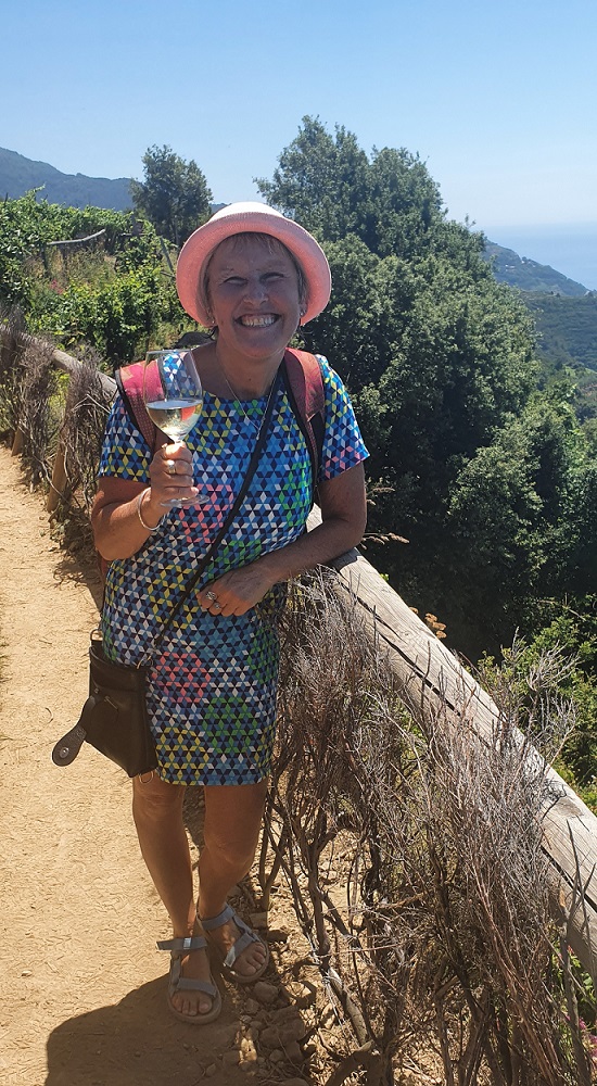 Lynn drinking wine near Manarola